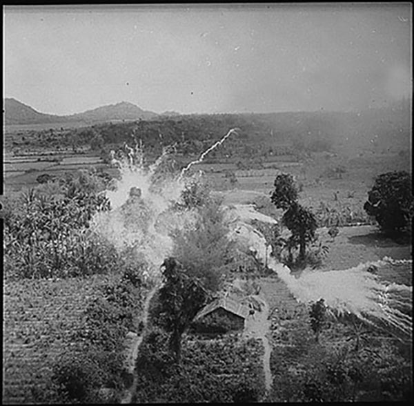 Less-than-precise application of force: U.S. jets napalm buildings suspected of harboring Viet Cong south of Saigon, 1965.